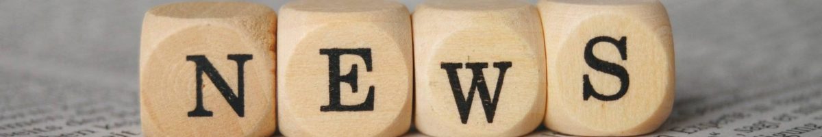 the word news on cubes on a newspaper